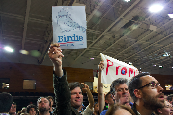 A supporter holds up a hand-made sign at the rally, eluding to when a small bird landed on Sanders' podium at a rally in Portland, Oregon last month. Photo by Kristen Warfield. 
